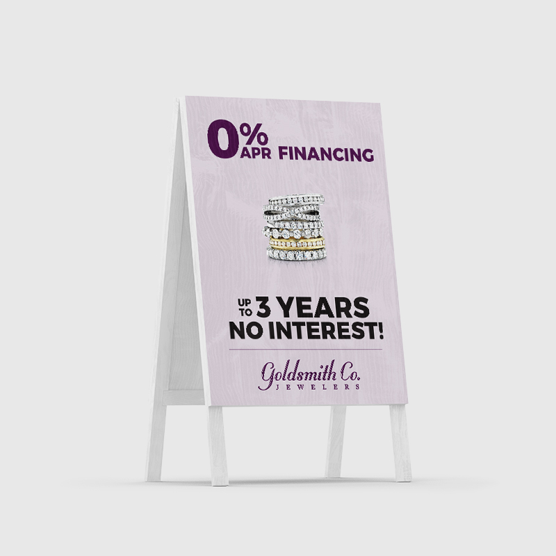 a-frame sandwich board with purple background featuring rings, financing information, and goldsmith logo